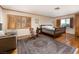 Spacious bedroom with hardwood floors, shuttered windows, seating area, and a comfortable bed at 2917 Chapala Dr, Las Vegas, NV 89120