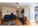 The well-lit bedroom includes hard wood floors, a futon, and an exercise machine at 2917 Chapala Dr, Las Vegas, NV 89120