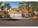 Charming two-story home showcases a spacious three-car garage and well-maintained front yard at 2917 Chapala Dr, Las Vegas, NV 89120
