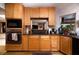 Modern kitchen with wooden cabinets, granite countertops, and updated appliances, ideal for meal preparation at 2917 Chapala Dr, Las Vegas, NV 89120