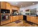 Functional kitchen with wooden cabinets, granite countertops, and stainless steel appliances, ready for cooking at 2917 Chapala Dr, Las Vegas, NV 89120