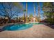 Beautiful backyard pool surrounded by mature trees, tall palms, and a patio perfect for outdoor relaxation at 2917 Chapala Dr, Las Vegas, NV 89120