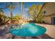 Sparkling pool with landscaped backyard oasis, mature palm trees, and patio, creating a serene retreat at 2917 Chapala Dr, Las Vegas, NV 89120