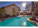 Backyard showcasing a private pool, lush greenery, and a glimpse of the home's exterior at 2917 Chapala Dr, Las Vegas, NV 89120