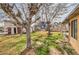 View of the backyard with mature trees and shed at 3567 Horizon Cir, Las Vegas, NV 89121