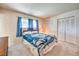 Comfortable bedroom featuring a queen bed, large window, and double closet, offering ample storage at 3567 Horizon Cir, Las Vegas, NV 89121