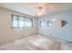 Simple bedroom with window, carpet, and accent mirrors, awaiting personal touches for a cozy retreat at 3567 Horizon Cir, Las Vegas, NV 89121