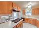Cozy kitchen featuring wooden cabinets, gas cooktop island, and vintage-style countertops and appliances at 3567 Horizon Cir, Las Vegas, NV 89121