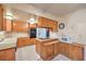 Functional kitchen with wooden cabinets and essential appliances for cooking needs at 3567 Horizon Cir, Las Vegas, NV 89121