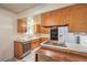 Functional kitchen with wooden cabinets and essential appliances for cooking needs at 3567 Horizon Cir, Las Vegas, NV 89121