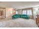 Spacious living room with large window, comfortable seating and carpeted floors at 3567 Horizon Cir, Las Vegas, NV 89121