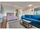 Open living room with a blue sofa and a cozy bedroom area at 3726 Las Vegas Blvd # 2407, Las Vegas, NV 89158