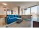 Open living room with a blue sofa, stainless steel appliances, and city views at 3726 Las Vegas Blvd # 2407, Las Vegas, NV 89158