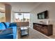 Bright living room with a blue sofa and a comfortable lounging area at 3726 Las Vegas Blvd # 2407, Las Vegas, NV 89158