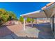 Backyard featuring a covered patio, gravel, mature trees, and a perimeter wall for added privacy at 451 Concord Way, Henderson, NV 89015