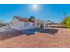 A bright backyard featuring a covered patio with red tile roof, shed, and rock landscaping at 451 Concord Way, Henderson, NV 89015