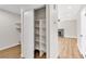 Spacious closet with custom shelving in a home with wood flooring and a fireplace at 451 Concord Way, Henderson, NV 89015