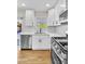 Kitchen featuring white cabinetry, stainless steel appliances, and light wood flooring at 451 Concord Way, Henderson, NV 89015