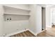 Laundry room with floating shelves and closet featuring wood floors and washer/dryer hookups at 451 Concord Way, Henderson, NV 89015