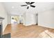 Open living room with a fireplace, ceiling fan, and views of the backyard at 451 Concord Way, Henderson, NV 89015