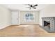 Spacious living room with a ceiling fan and a cozy brick fireplace at 451 Concord Way, Henderson, NV 89015