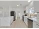 Modern kitchen featuring new stainless steel appliances, marble countertops, and white cabinets at 457 Leighann Rd, Henderson, NV 89015