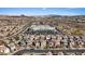 Aerial view showcases the neighborhood's layout, highlighting a nearby school, residential homes and mountain backdrop at 460 Accelerando Way, Henderson, NV 89011