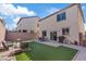 Beautiful backyard featuring artificial grass, patio, a grill, and comfortable outdoor seating, perfect for entertaining at 460 Accelerando Way, Henderson, NV 89011