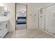 Modern bathroom featuring a glass shower, tiled floor, and view into the bedroom at 460 Accelerando Way, Henderson, NV 89011