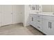 Bathroom boasts dual sinks with white cabinets and matte black hardware at 460 Accelerando Way, Henderson, NV 89011