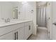 Bathroom with dual sinks, white cabinets, and a view of the toilet and shower at 460 Accelerando Way, Henderson, NV 89011