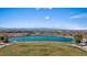 Community lakeside view features a tranquil turquoise lake surrounded by grassy areas and city views, enhancing outdoor appeal at 460 Accelerando Way, Henderson, NV 89011