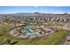 Overhead view of a community park with a play structure, green space, and trees against a backdrop of suburban homes at 460 Accelerando Way, Henderson, NV 89011