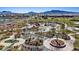 Expansive community park with winding walkways, lush landscaping, playgrounds, and mountain views in a Gathering-friendly neighborhood at 460 Accelerando Way, Henderson, NV 89011