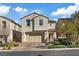 Lovely two-story home with tile roof, attached garage, desert landscaping, and paved driveway at 460 Accelerando Way, Henderson, NV 89011