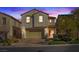 Charming two-story home with a well-manicured lawn, two car garage, and inviting front entrance at 460 Accelerando Way, Henderson, NV 89011