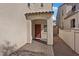 Inviting covered front entryway with pavers and a red front door at 460 Accelerando Way, Henderson, NV 89011