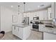 Bright kitchen featuring white cabinetry, stainless steel appliances, and granite countertops at 460 Accelerando Way, Henderson, NV 89011