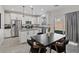Bright eat-in kitchen with stainless steel appliances, white cabinetry, and gray countertops at 460 Accelerando Way, Henderson, NV 89011