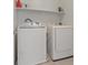 Bright laundry room featuring a modern washer and dryer, along with ample shelving for storage at 460 Accelerando Way, Henderson, NV 89011