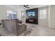Open concept living room with fireplace and ceiling fan at 460 Accelerando Way, Henderson, NV 89011