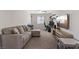 Cozy living room featuring a comfortable sectional sofa, TV, and desk area at 460 Accelerando Way, Henderson, NV 89011