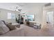 Relaxing living room with sectional couch, TV, and a view to the bedroom at 460 Accelerando Way, Henderson, NV 89011