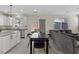Open concept living space with a kitchen, dining table, and a comfortable seating area at 460 Accelerando Way, Henderson, NV 89011