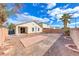 Backyard featuring brick patio area, desert landscaping, rock ground cover, and perimeter block wall at 4837 Morning Splash Ave, Las Vegas, NV 89131