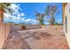 Large, sunny backyard with desert landscaping, rock ground cover, and perimeter block wall at 4837 Morning Splash Ave, Las Vegas, NV 89131