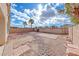 Backyard featuring brick seating area, desert landscaping, rock ground cover, and block privacy wall at 4837 Morning Splash Ave, Las Vegas, NV 89131