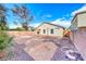 Large, sunny backyard with desert landscaping, rock ground cover, and perimeter block wall at 4837 Morning Splash Ave, Las Vegas, NV 89131
