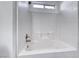 Bright white tiled shower-over-tub with a small window for natural light at 4837 Morning Splash Ave, Las Vegas, NV 89131