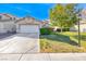 Exterior shot of a single story home showcasing the front yard, garage, and inviting curb appeal at 4837 Morning Splash Ave, Las Vegas, NV 89131